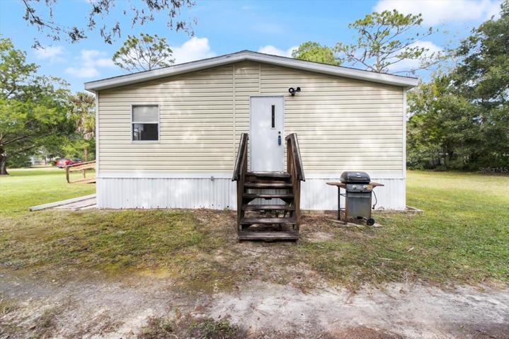 View of the home's side entrance into the laundry room and kitchen