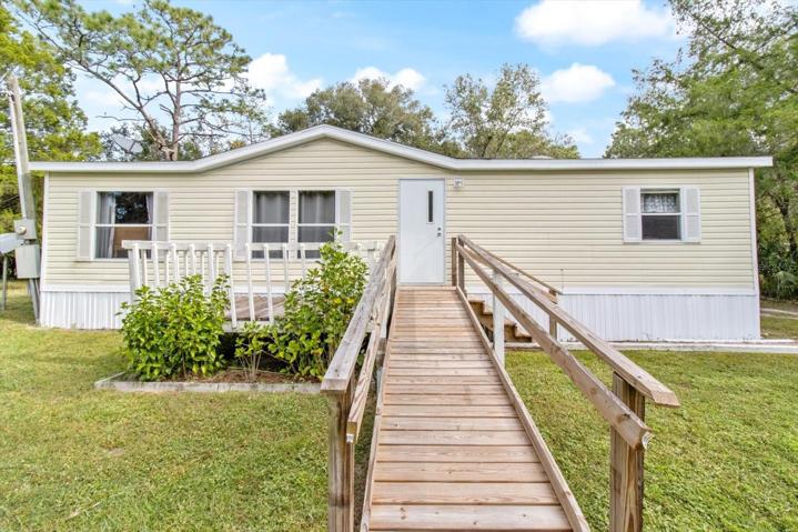 charming 1,188 sq ft home with 3 bedrooms and 2 bathrooms nestled on a spacious 1/2-acre lot, providing a serene country setting.  Accessible ramp entry into the 2003 built home.