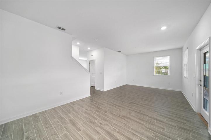 Wood-look ceramic tile floors run throughout the first floor