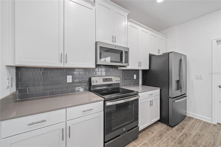 Stainless steel fingerprint resistant appliances and lovely subway tile backsplash