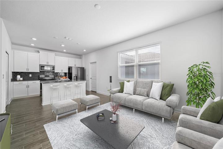 Virtually staged - Views out to the back patio and breezeway from the kitchen/family room