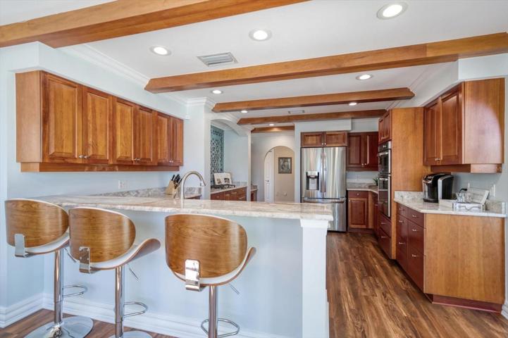 Beautifully remodeled with thoughtful improvements, the kitchen is a dream for culinary enthusiasts! Attractive granite counters, gas cook top, separate pantry and much more.