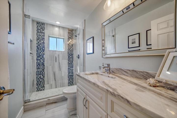 Guest bathroom also services the two additional bathrooms. Lovey tile work, beautiful usage of granite.