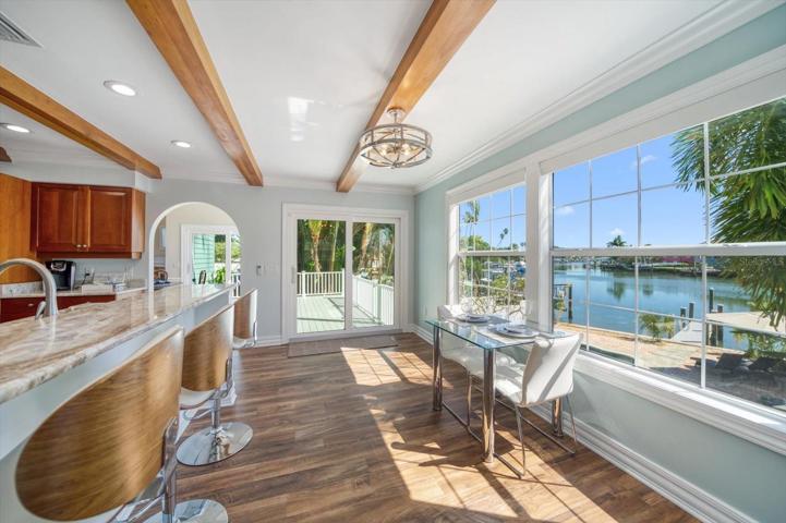 Kitchen and eat in area is detailed by a custom beamed ceiling and spacious breakfast bar. Enjoy your coffee and the views!
