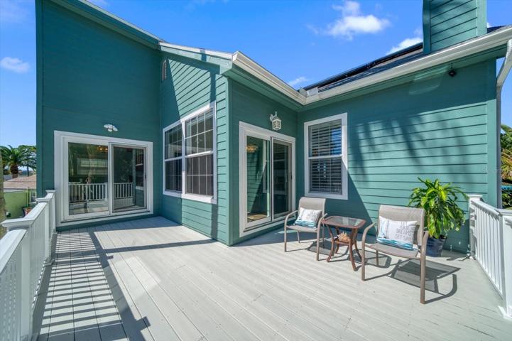 Spacious deck off kitchen area made of composite flooring material allows for outdoor enjoyment- all year!