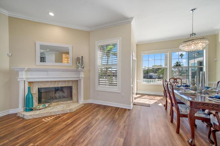 Wood burning fireplace for cooler evenings sets the stage for entertaining in the lovely large dining area.