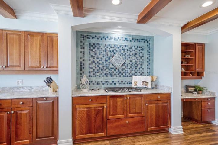 Attractive updates include gleaming granite counters, natural gas range, detailed backsplash and custom cabitnetry.