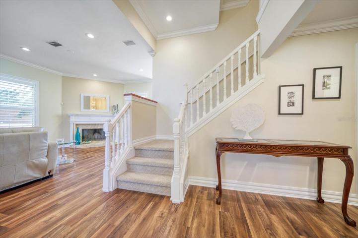 Great room with attractive fireplace, luxury vinyl flooring and custom moldings.
