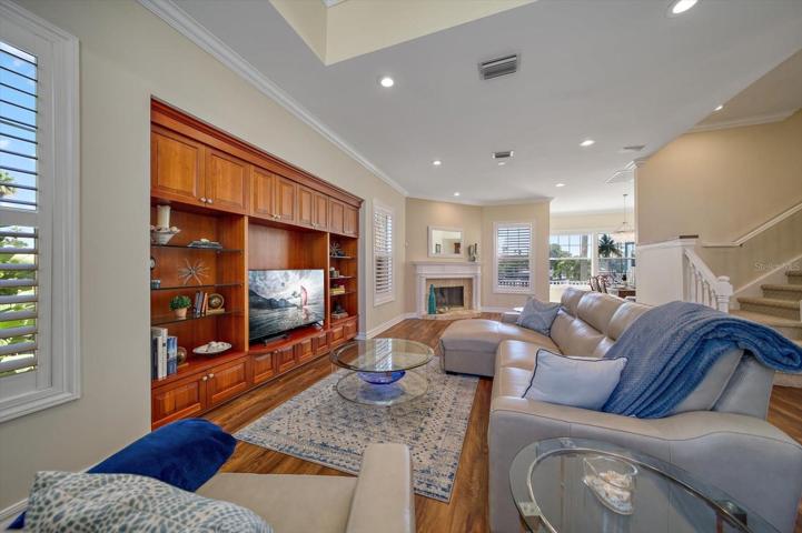 Lovely great room area with attractive custom built in entertainment center and inviting fireplace.