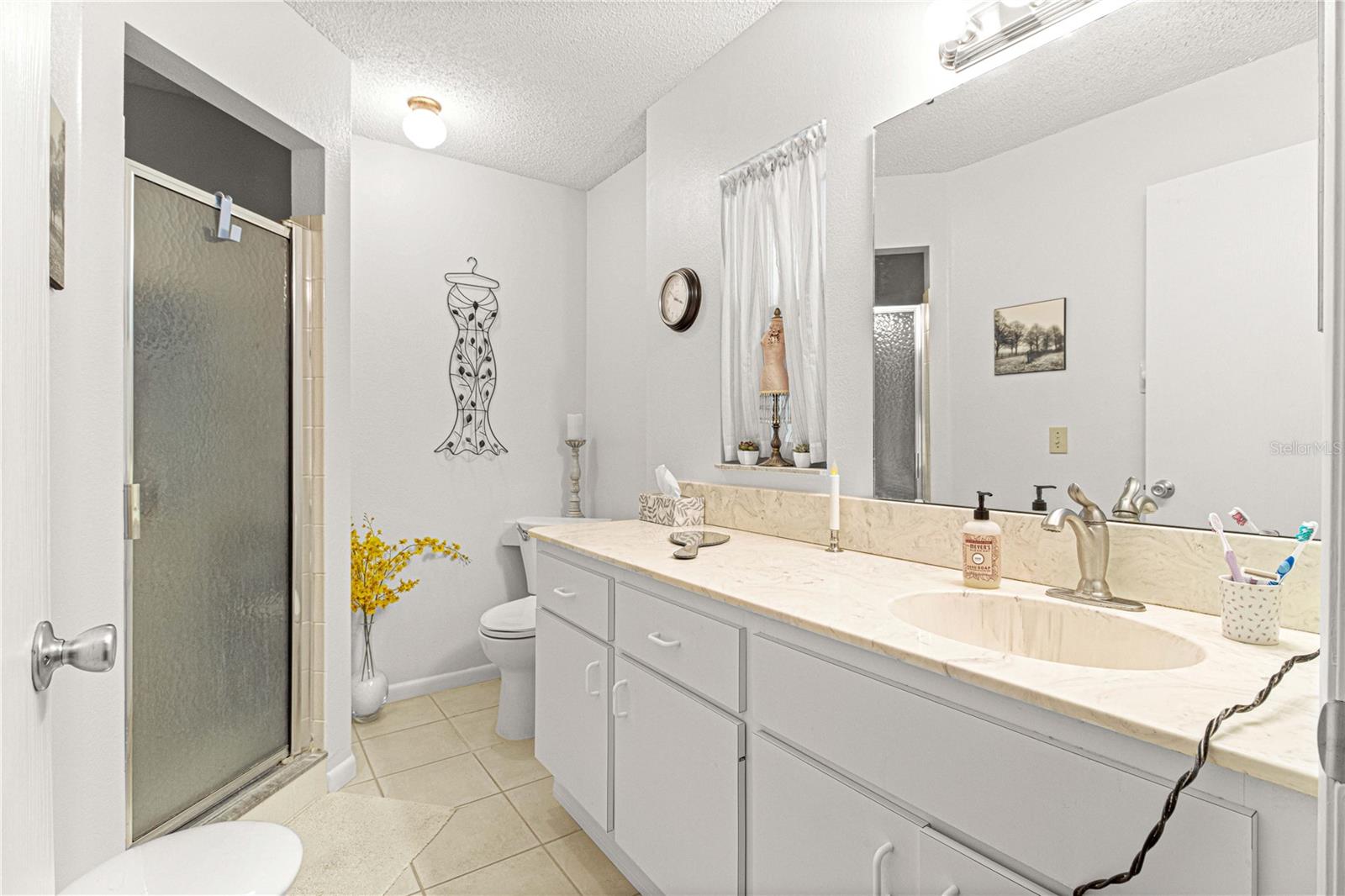 Master bath with cultured marble vanity and step in shower