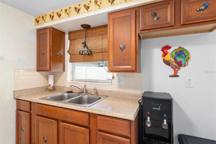 Kitchen with Window Overlooking Fenced Yard