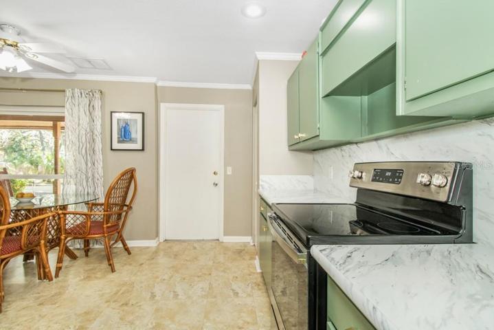 Kitchen features a new range, a stainless-steel fridge, and ample counter space.