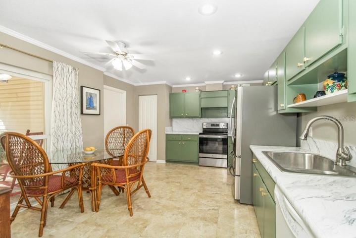 Kitchen features a new range, a stainless-steel fridge, and ample counter space.