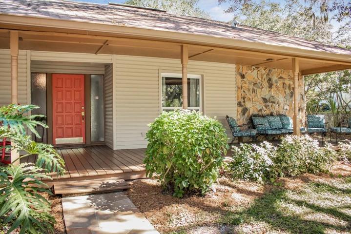 Large front porch that exudes Southern charm and provides the perfect spot to sit on your cozy outdoor furniture creating a welcoming and inviting space.