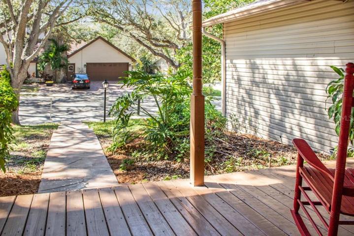 Large front porch that exudes Southern charm and provides the perfect spot to sit on your cozy outdoor furniture creating a welcoming and inviting space.