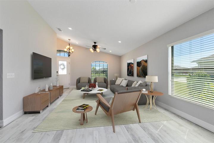 This photo has been virtually staged. A view back to the front door from the dining area.