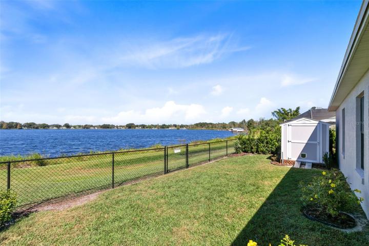 Outside, the fenced backyard treats you to panoramic lake views, making it the perfect setting for outdoor gatherings, picnics, or simply soaking in the beauty of nature.