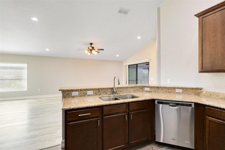 A granite topped breakfast bar provides an additional seating area.