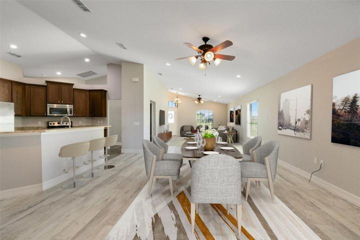 This photo has been virtually staged. Looking from the dining room to the living room and kitchen.