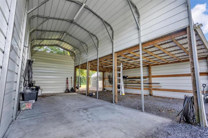 30x12 RV Carport with additional overhang (green house behind in back)