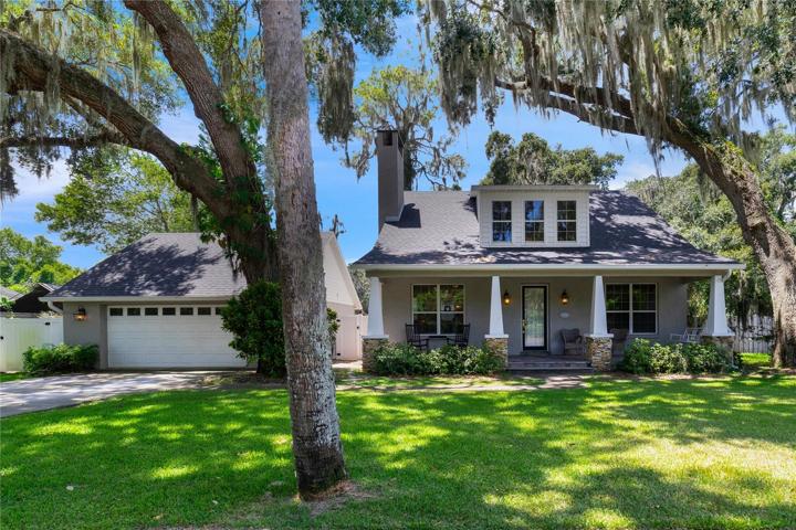 Mount Dora charmer with a BRAND NEW ROOF (2023), completely REMODELED KITCHEN, spacious bedrooms, bonus space, PULL THROUGH GARAGE and community access to LAKE DORA!