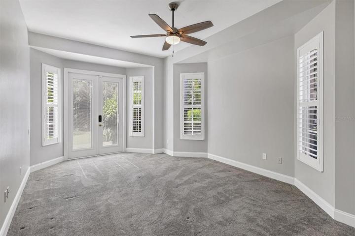 2nd bedroom with french doors(high  impact) with large closet, and plantation shutters.