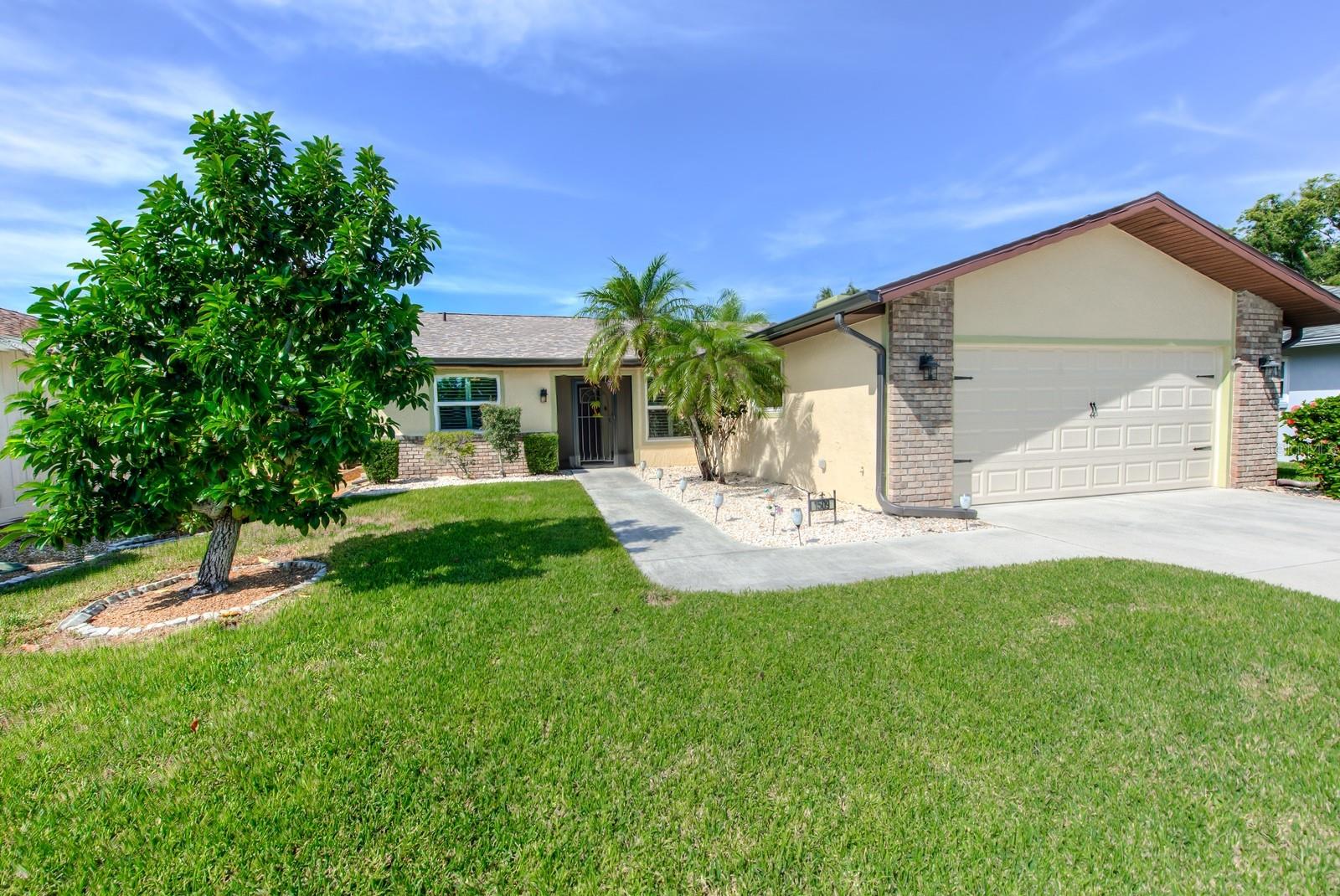 Beautiful tropical landscaping and a mature avocado tree welcome you home. The brick trim was replaced in 2020, a steel hurricane rated side door from the garage was installed in 2018 and the exterior of the home was repainted in 2021. A brand new garage door open was recently installed.