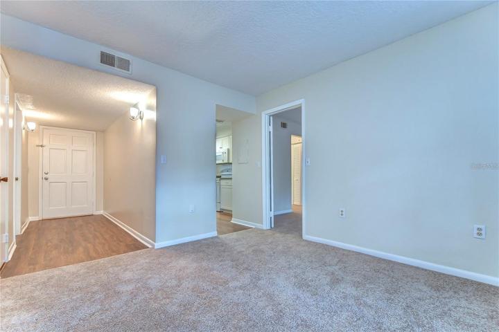 View of entry hall, kitchen and 2nd bedroom door open