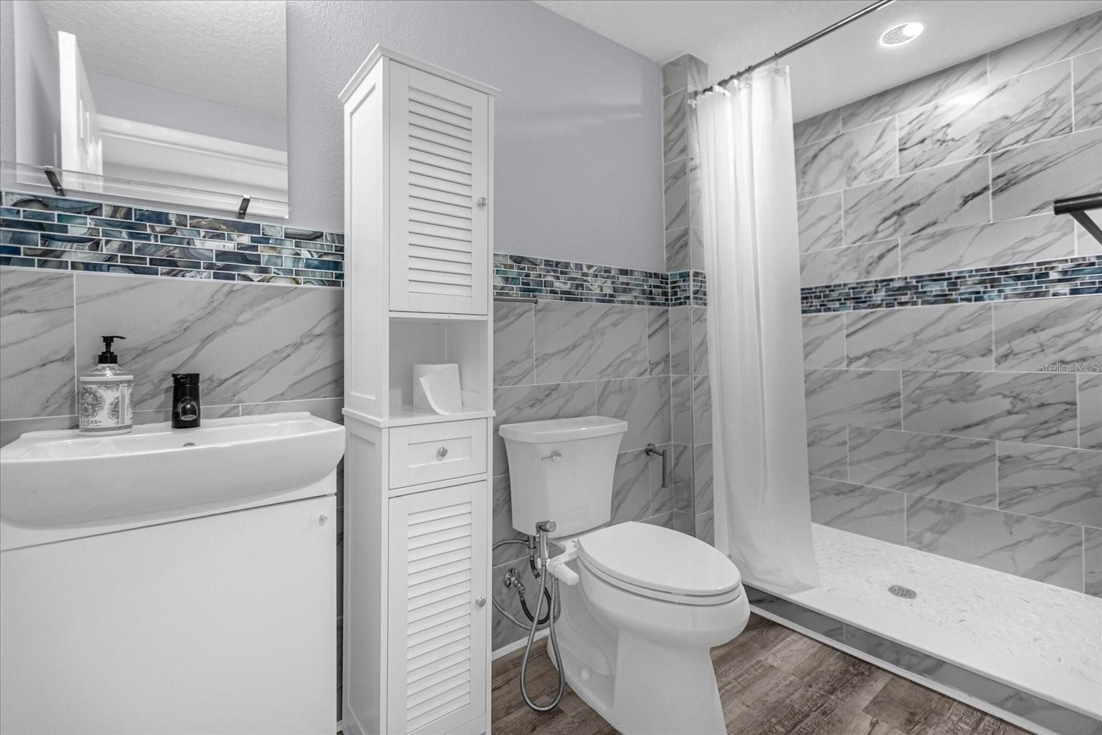 full bath with shower towards office area of unit