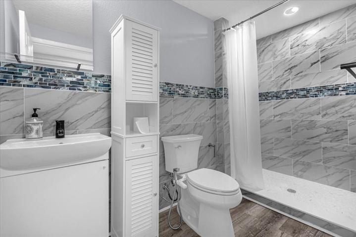 full bath with shower towards office area of unit