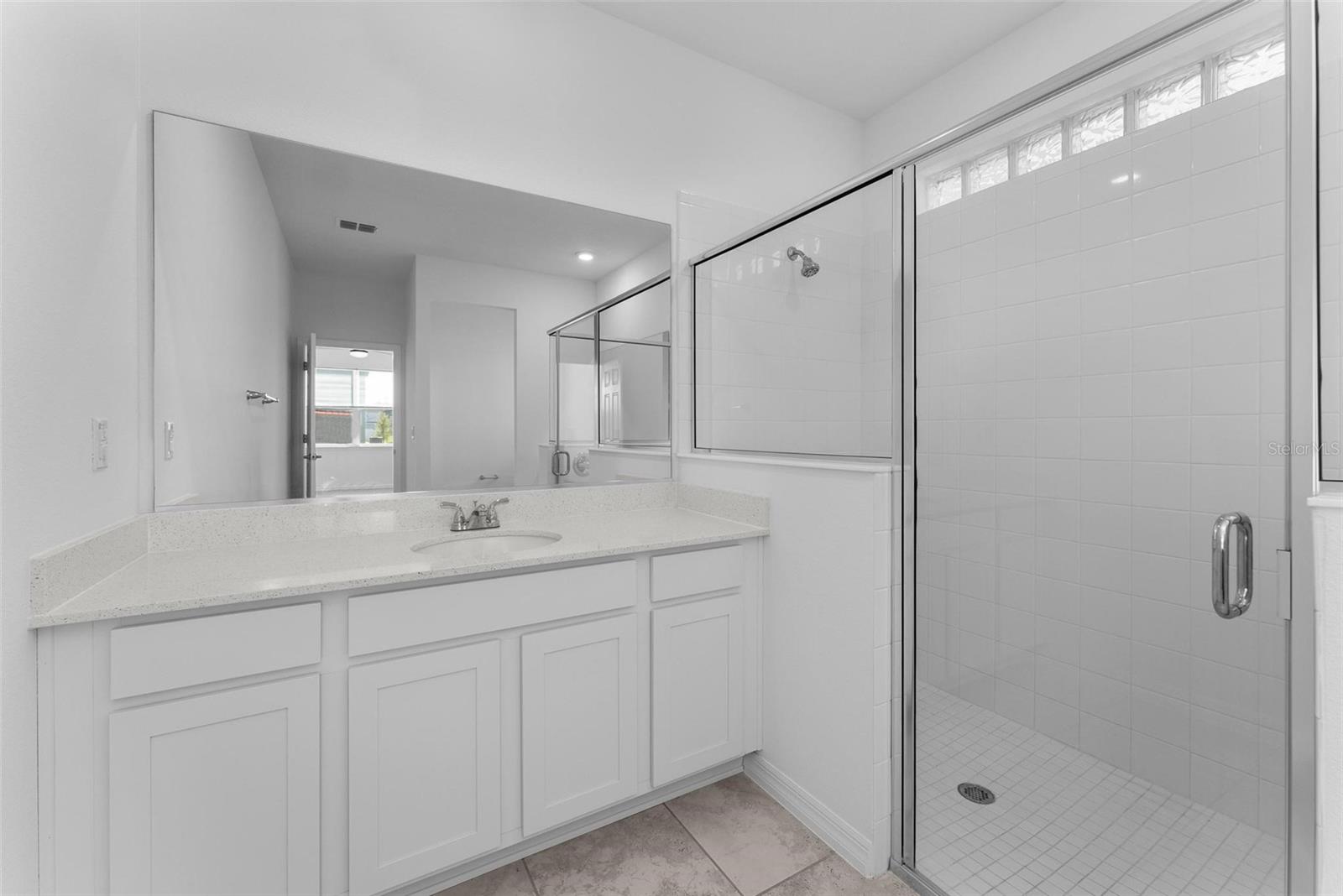 Primary bathroom w/ dual sinks and large shower