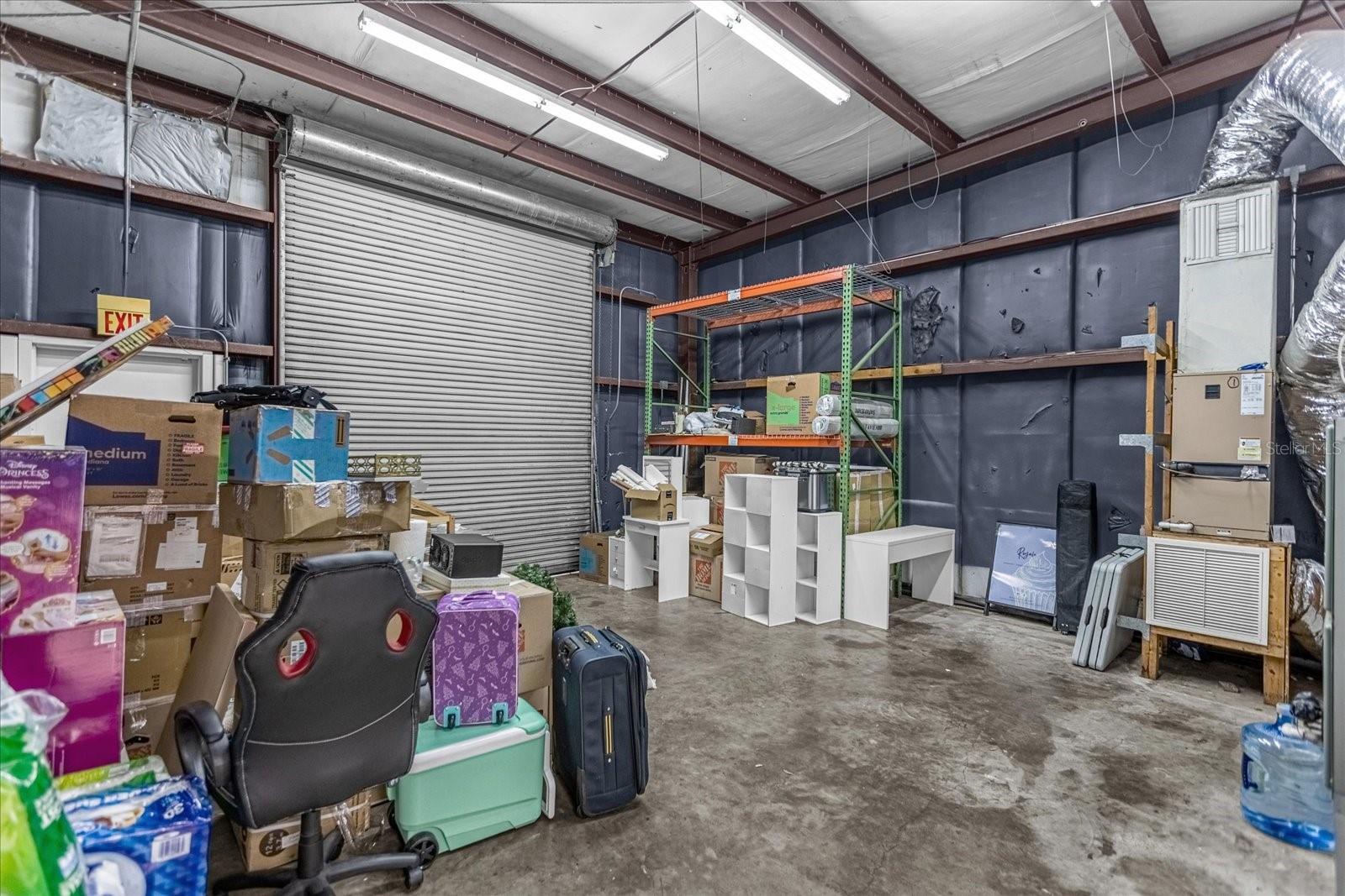 Storage warehouse area height to beam is approx 14' 7", bay door at ground level. 9Ft wide
