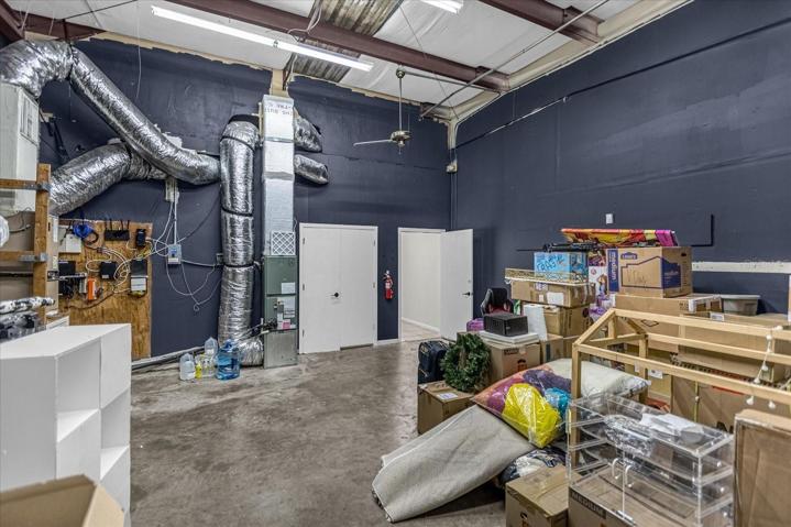 Storage warehouse area height to beam is approx 14' 7", bay door at ground level. 9Ft wide
