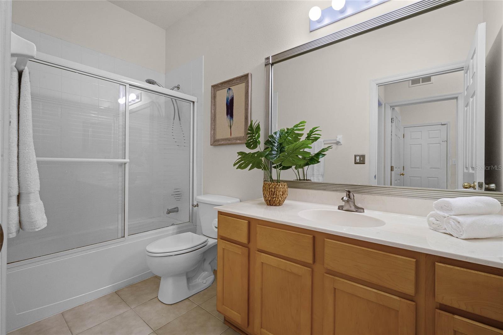 Bathroom #2 w/ single sink & tub w/ shower