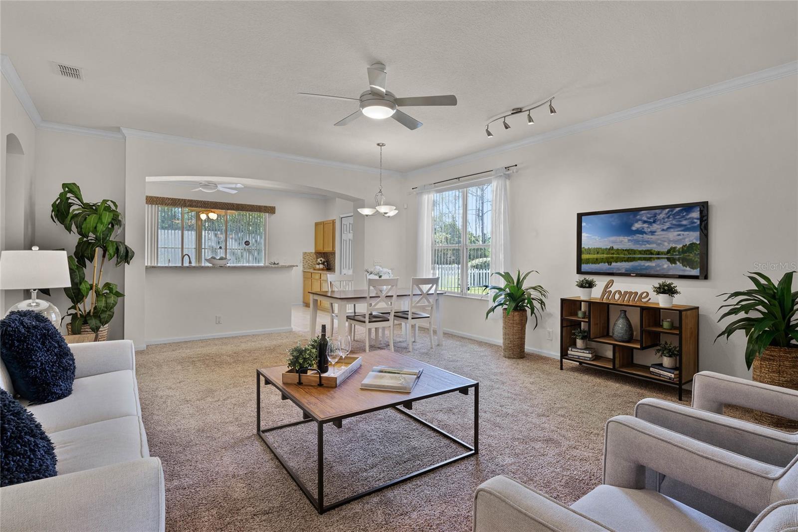 17'6" x 21' Great Room w/ crown molding, ceiling fan & track lighting
