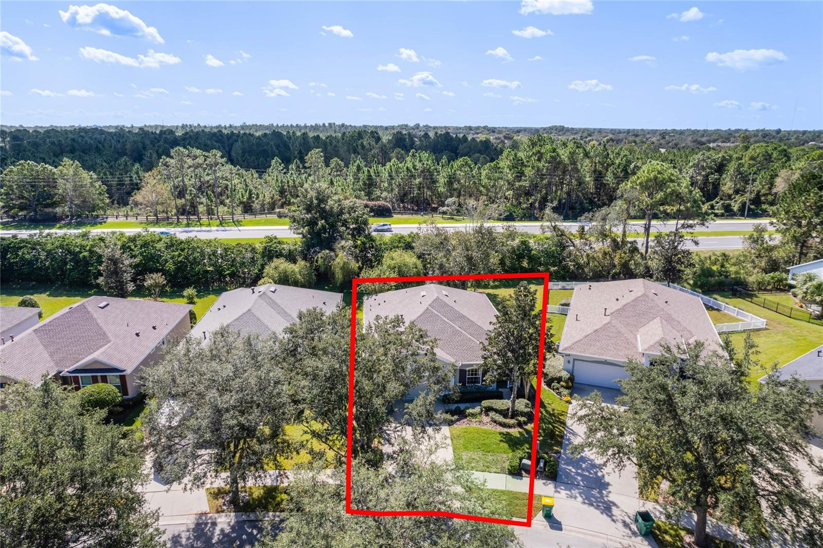 Aerial view of front of home w/ landscape berm in backyard