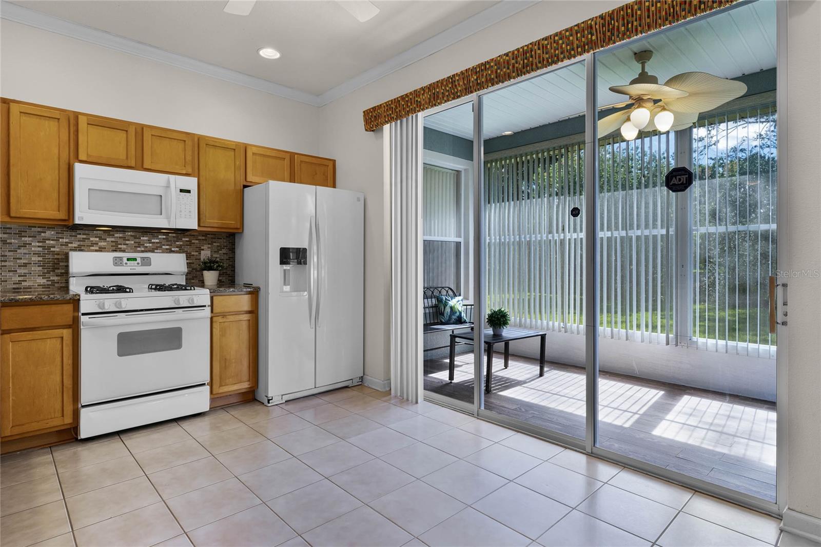 17'6" x 10'6" Kitchen area & enclosed lanai w/ luxury vinyl flooring