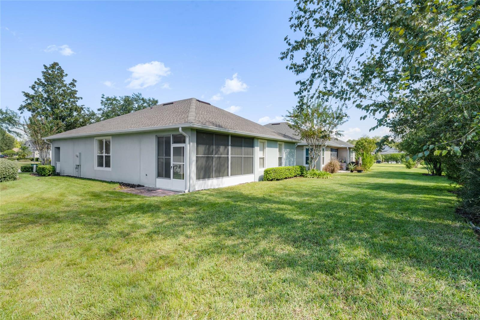 Exterior rear of home w/ a spacious backyard