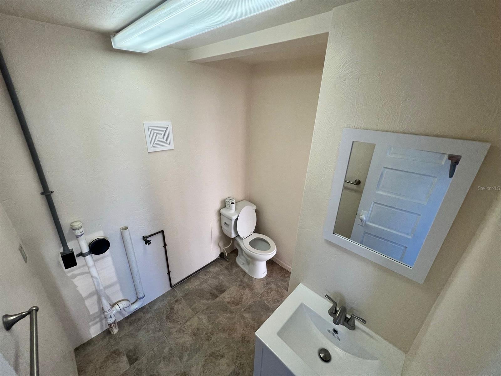 Unit C half bath with washer / dryer hook up.