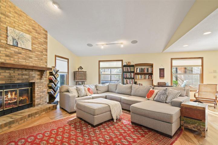 Solid hickory wood floors grace the main living areas where you have your choice of living rooms on either side of the kitchen both delivering SOARING CEILINGS, brick front FIREPLACES and the perfect space to entertain friends and family with ease!