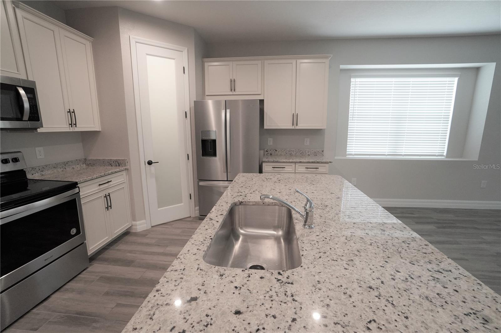 Granite countertops, 42" cabinets, closet pantry and stainless steel appliances