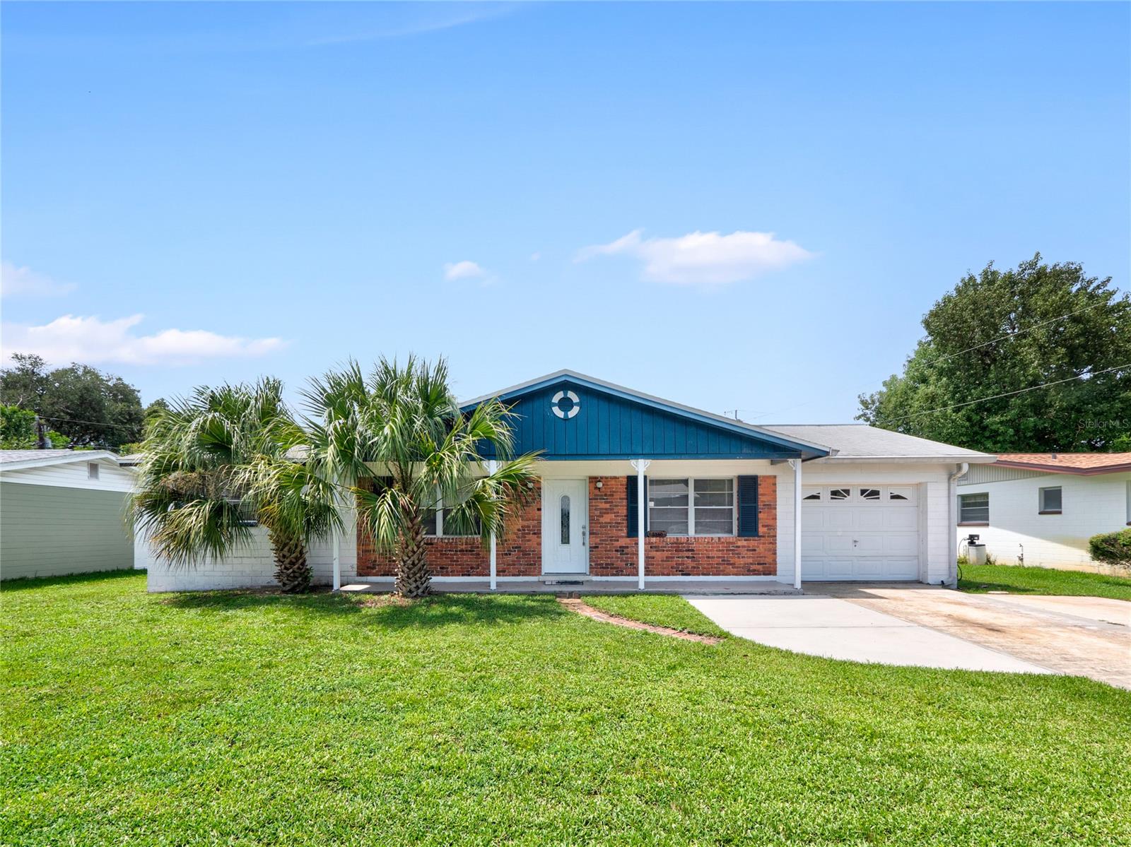 Solid concrete block home with 1-car garage + extended parking pad