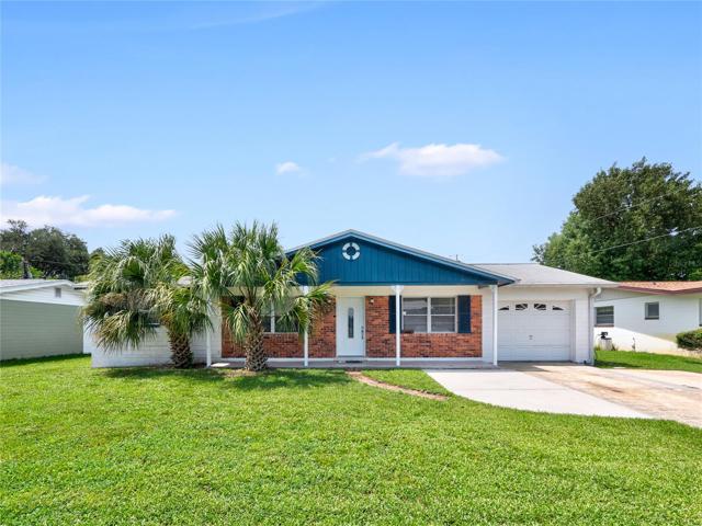 Solid concrete block home with 1-car garage + extended parking pad