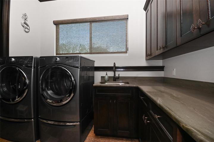 Laundry Room has extra storage and 2nd pantry