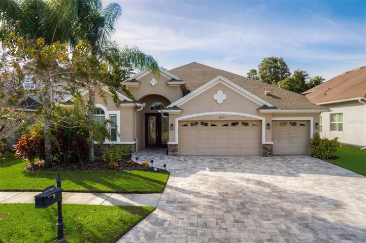 Curb appeal abounds! Mature landscaping, lighting, pavers, and the dual door entry are just a few of the key design features that will welcome you home!