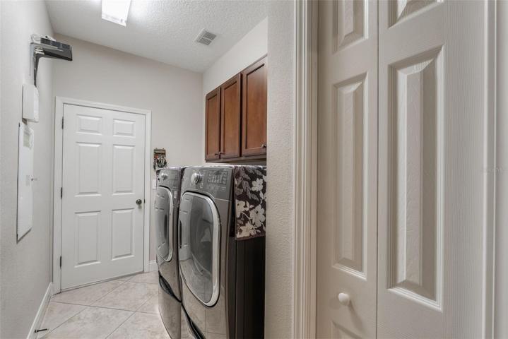 Laundry room with wash basin and closet.