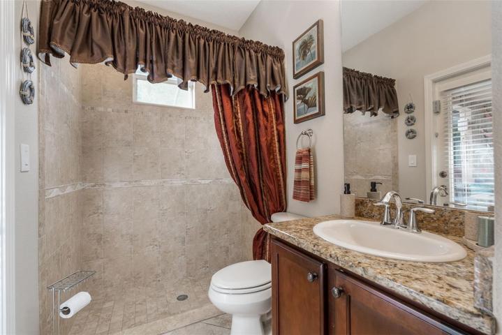 Pool Bathroom leads right out the covered lanai and caged pool area.