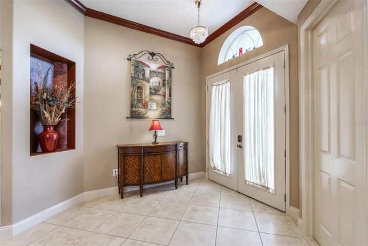 Plenty of space to greet your guests in style. To the right of the entry you'll find the dual door den with super tall doors and volume ceilings  (doors presently closed in picture)