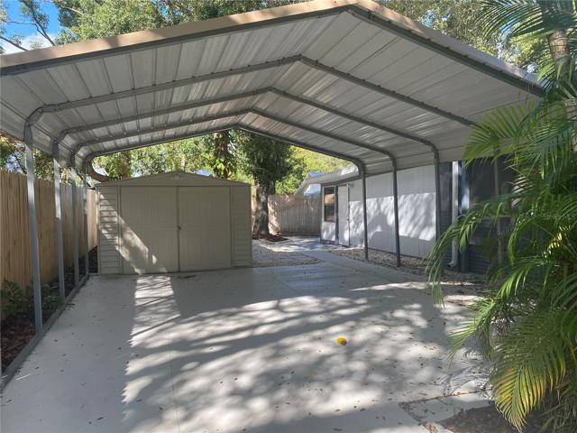 2 car carport and shed with entry to bonus rooms