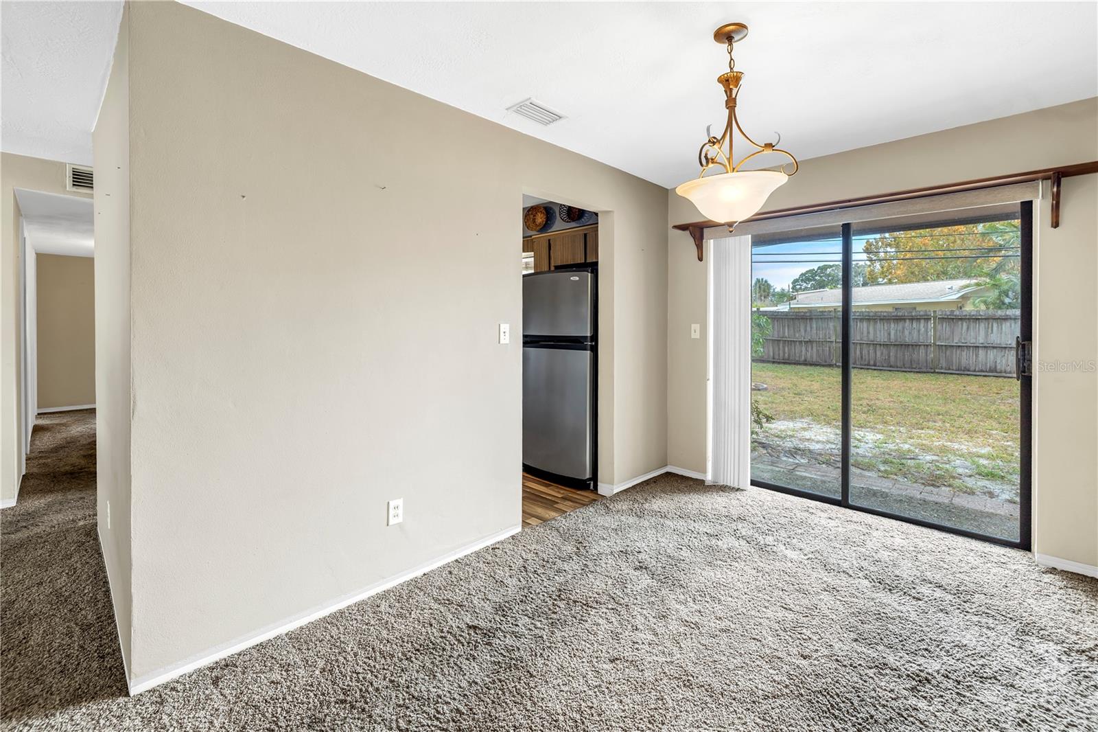 Kitchen entry from the Dining room and well conditioned sliders access the large and private backyard